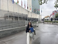 A photo of Ilana Nguyen standing in front of the United Nations building
